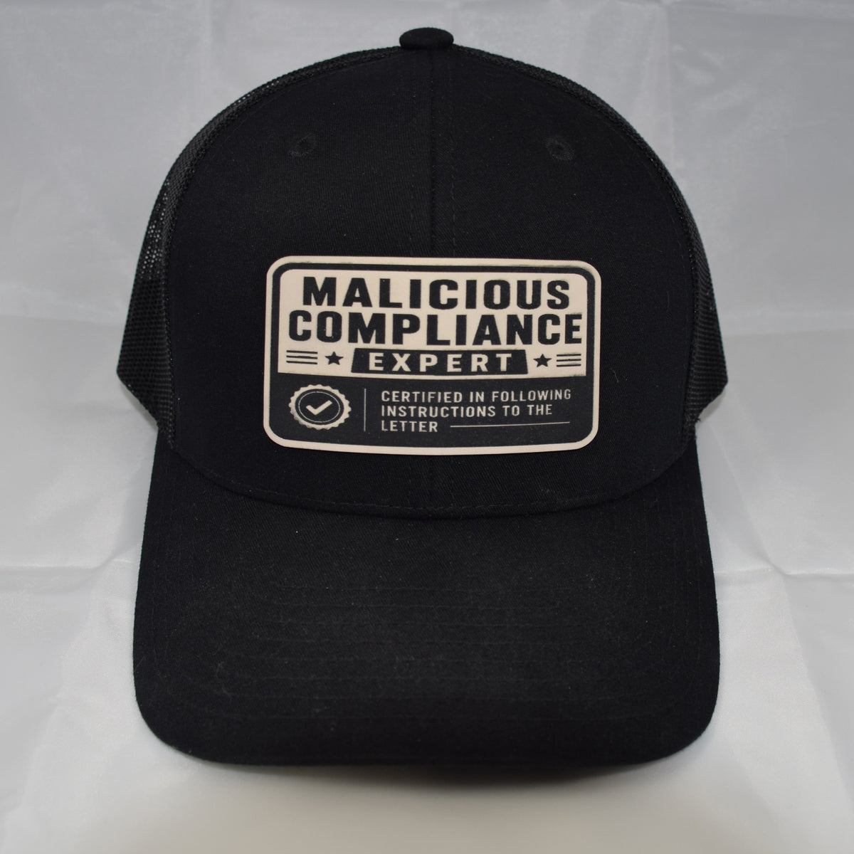 Malicious Compliance Mesh-Back Trucker Hat – Leatherette Patch