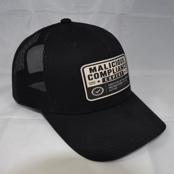 Malicious Compliance Mesh-Back Trucker Hat – Leatherette Patch